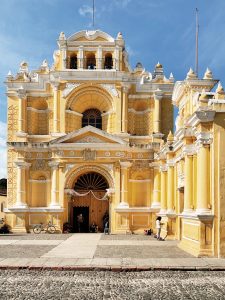 Historic yellow cathedral facade in Antigua Guatemala, showcasing remarkable colonial architecture.